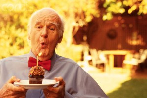 Senior Man Blowing out Birthday Candle