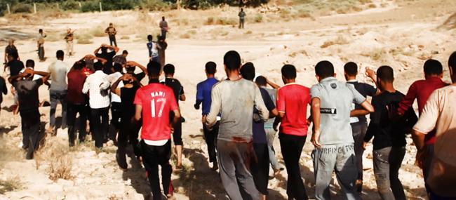 This image posted on a militant website on Saturday, June 14, 2014, which has been verified and is consistent with other AP reporting, appears to show militants from the al-Qaida-inspired Islamic State of Iraq and the Levant (ISIL) leading captured Iraqi soldiers wearing plain clothes to an open field moments before shooting them in Tikrit, Iraq. The Islamic militant group that seized much of northern Iraq has posted photos that appear to show its fighters shooting dead dozens of captured Iraqi soldiers in a province north of the capital Baghdad. Iraq's top military spokesman Lt. Gen. Qassim al-Moussawi confirmed the photos? authenticity on Sunday and said he was aware of cases of mass murder of Iraqi soldiers. (AP Photo via militant website)