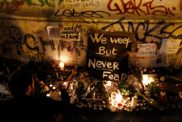 A man lights a candle in Republique square in Paris Nov. 14 in memory of victims of terrorist attacks. Coordinated attacks the previous evening claimed the lives of 129 people. The Islamic State claimed responsibility. (CNS photo/Paul Haring) See POPE-PARIS-TERROR Nov. 14, 2015 and PARIS-ATTACK-LOMBARDI Nov. 13, 2015.